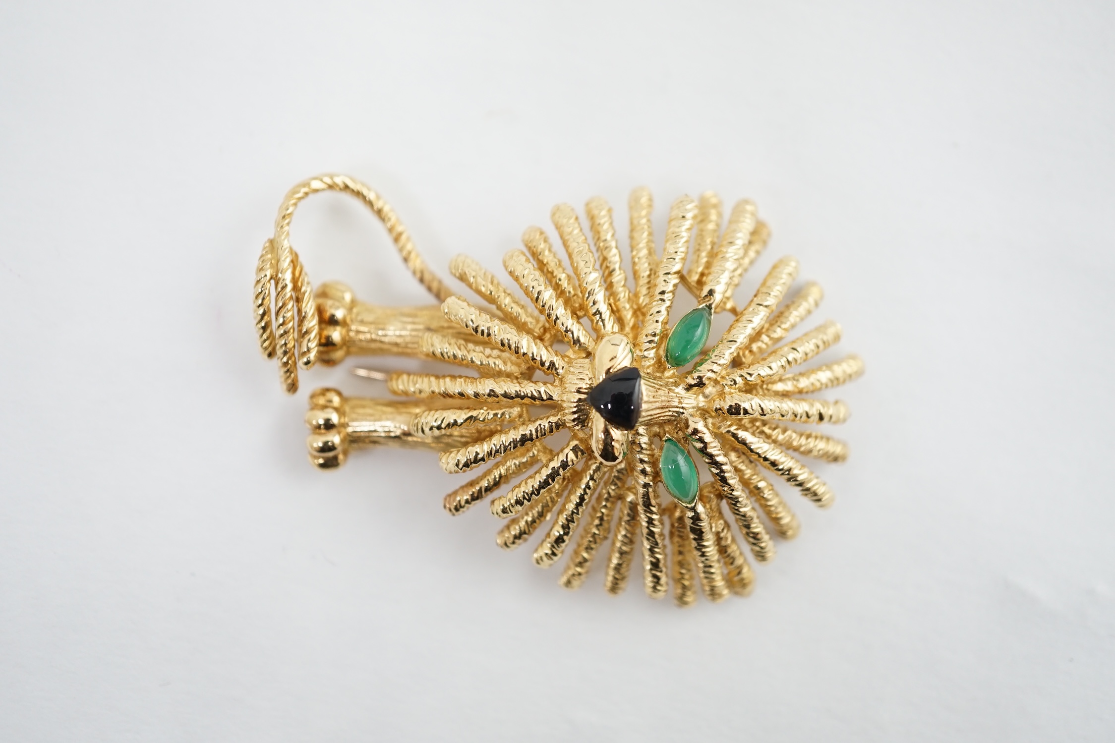 A stylised gold (tests as 18k) 'Lion King' clip brooch set chrysoprase and black enamel